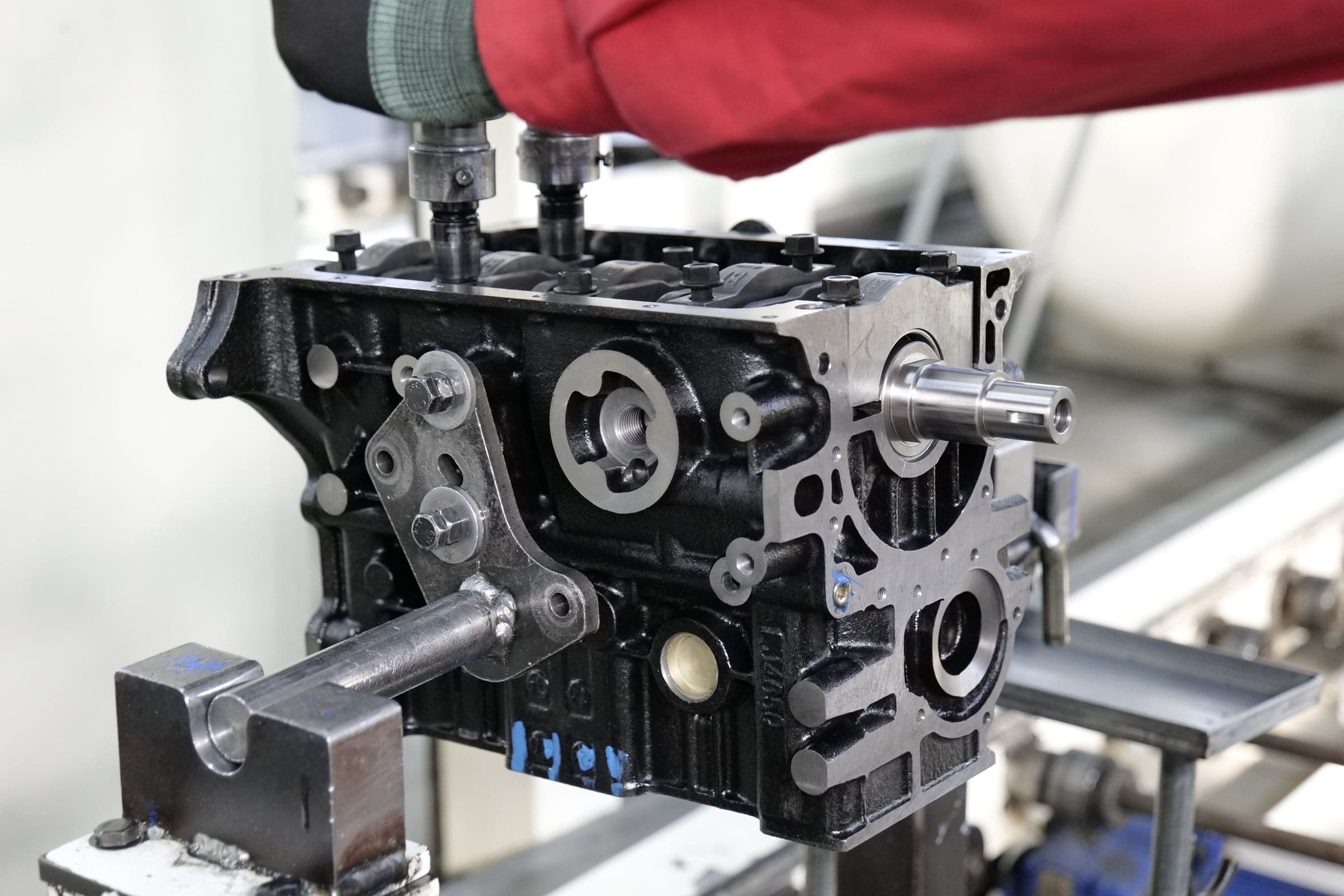 Engine block clamped in a fixture on the assembly line