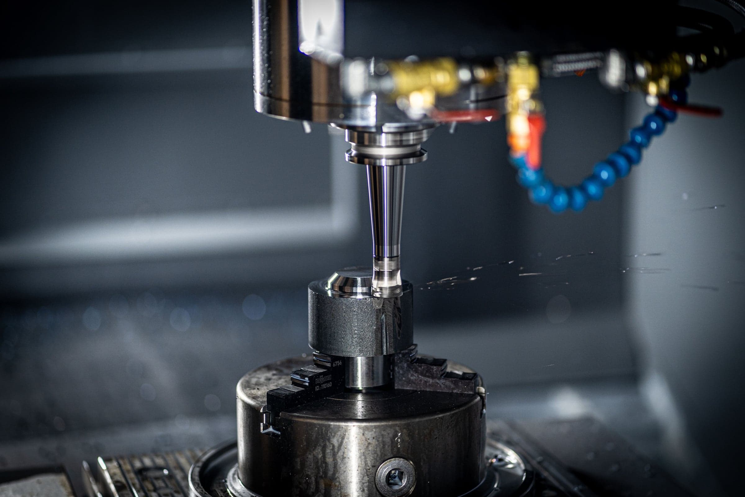 CNC milling head machining a workpiece with coolant